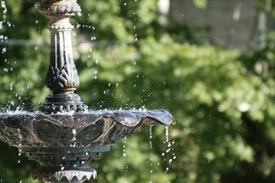 Close-up of water drops on fountain against blurred background