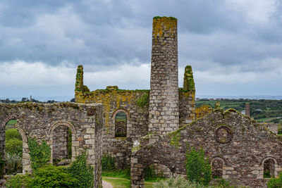 Old ruin building against cloudy sky