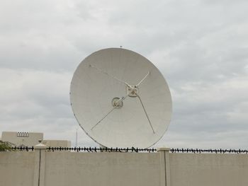 Satellite dish on terrace against sky