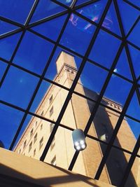 Low angle view of modern building against blue sky