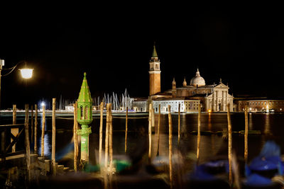 Illuminated temple against sky at night