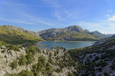 Scenic view of lake and mountains against sky