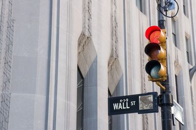 Low angle view of road signal against building