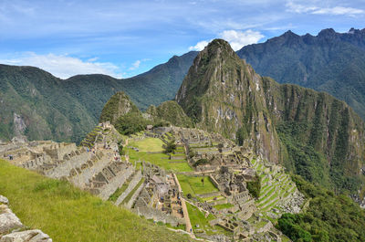 Scenic view of mountains against cloudy sky