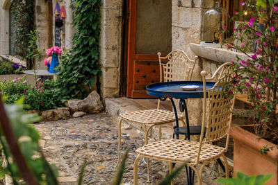 Empty chairs and tables in yard