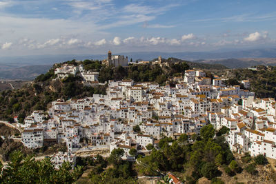 High angle view of cityscape against cloudy sky