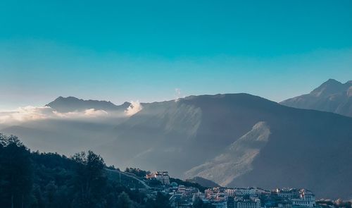 Scenic view of mountains against blue sky