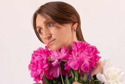 Portrait of woman with pink flower