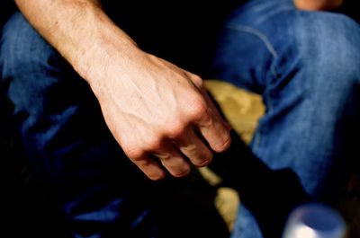 Cropped image of person sitting on chair