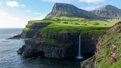 Scenic view of sea and rocks against sky