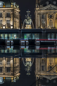 Reflection of building in city at night