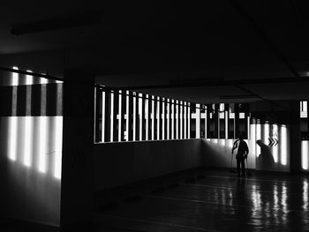 Rear view of silhouette woman walking in building