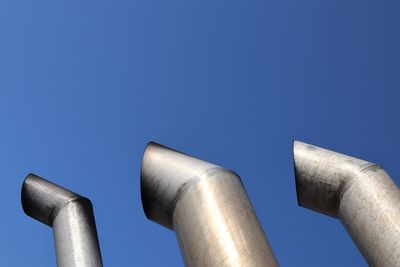 Low angle view of smoke stack against sky