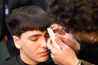 High angle view of man sitting in hair salon