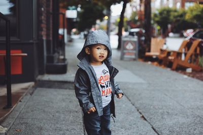 Cute boy standing on street