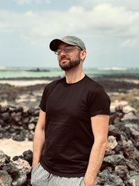 Young man standing at beach