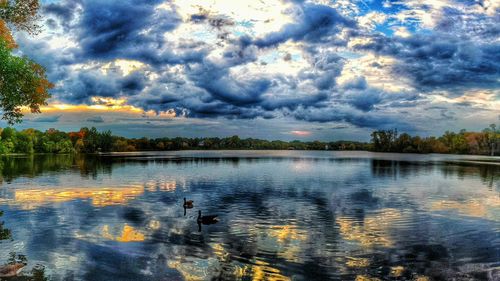 Scenic view of lake against cloudy sky