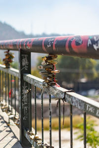 Close-up of padlock on railing against sky