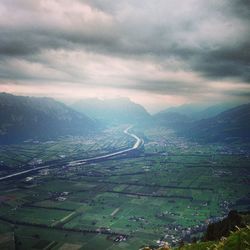 Scenic view of mountains against cloudy sky