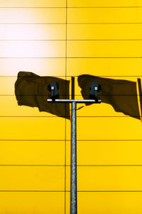 Shadow of flag on yellow wall