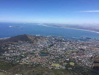 High angle view of city by sea against sky