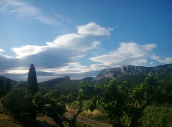 Scenic view of mountains against cloudy sky