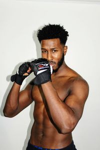 Portrait of young boxer against white background