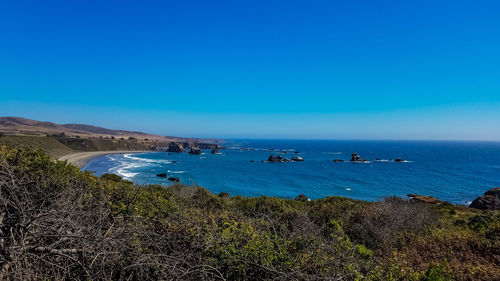 Scenic view of sea against clear blue sky