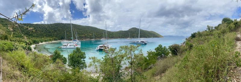 Panoramic shot of sailboats on sea against sky