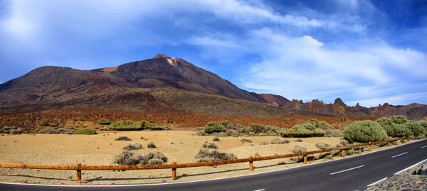 Scenic view of desert road against sky