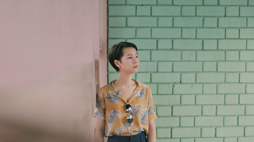 Woman standing against wall