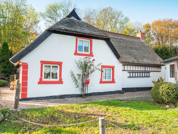 Colorful house with reeds roof in historical fishing village vitt at kap arkona, germany