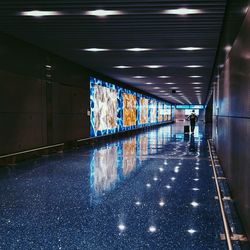 People walking in illuminated corridor