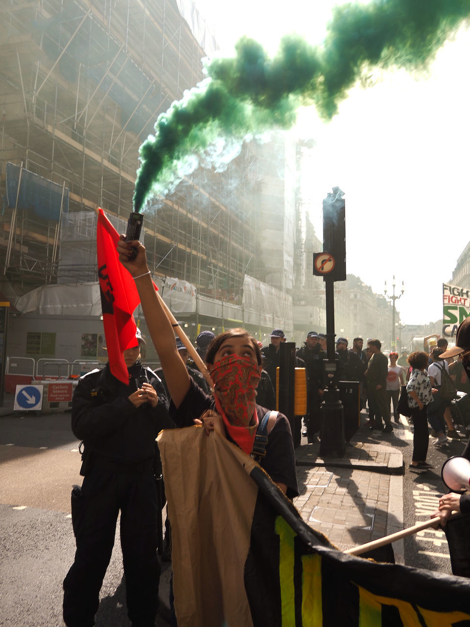 PEOPLE STANDING ON STREET AGAINST CITY