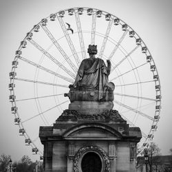 Low angle view of ferris wheel against sky