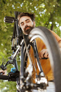 Low angle view of man riding bicycle