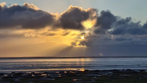 Scenic view of sea against sky at sunset