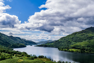 Scenic view of river amidst mountains against sky