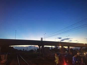 Train at railroad station against clear blue sky