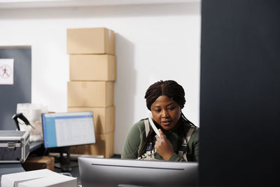 Young businesswoman using laptop at desk in office