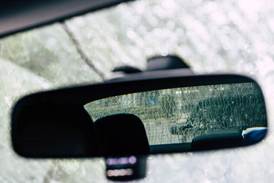 Reflection of car in side-view mirror