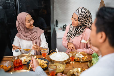 Side view of woman having food at home