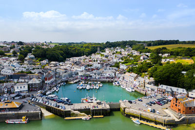 High angle view of cityscape by sea against sky