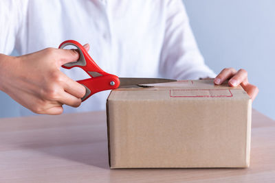 Midsection of woman holding box