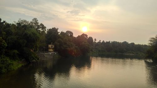 Scenic view of river at sunset