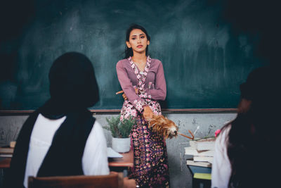 Woman looking at while sitting on seat