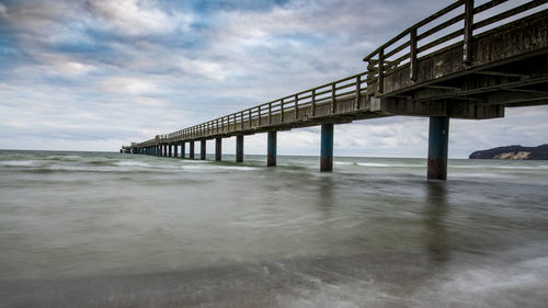 Pier over sea against sky