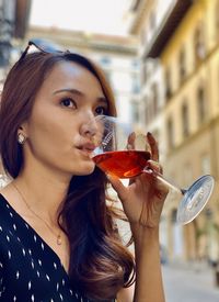 Portrait of a young woman drinking glass