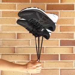 Close-up of person holding umbrella against brick wall