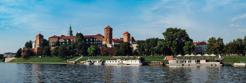 Panoramic view of he wawel castle in krakow, poland, in the foreground the vistula river.